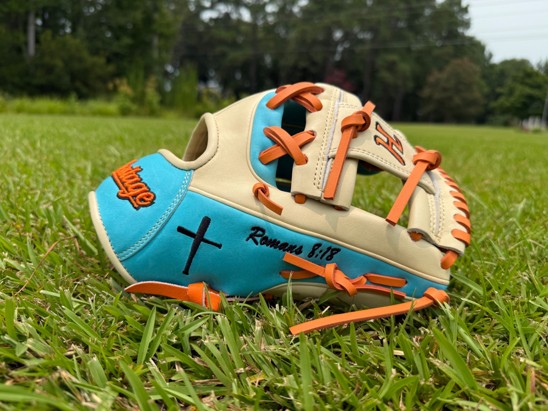 Cream and teal Heritage glove with cross and 'Romans 8:18' embroidery